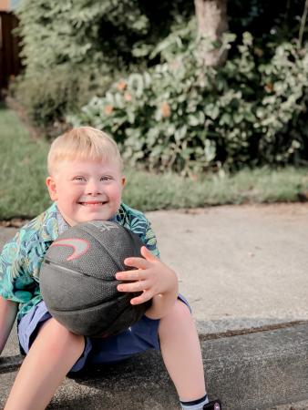 boy hugging basketball