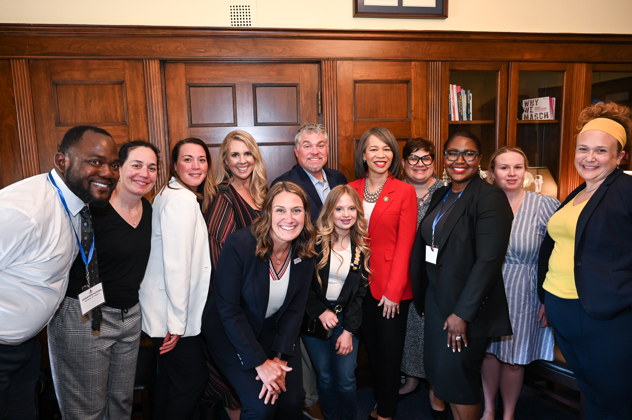 group stands with their member of congress